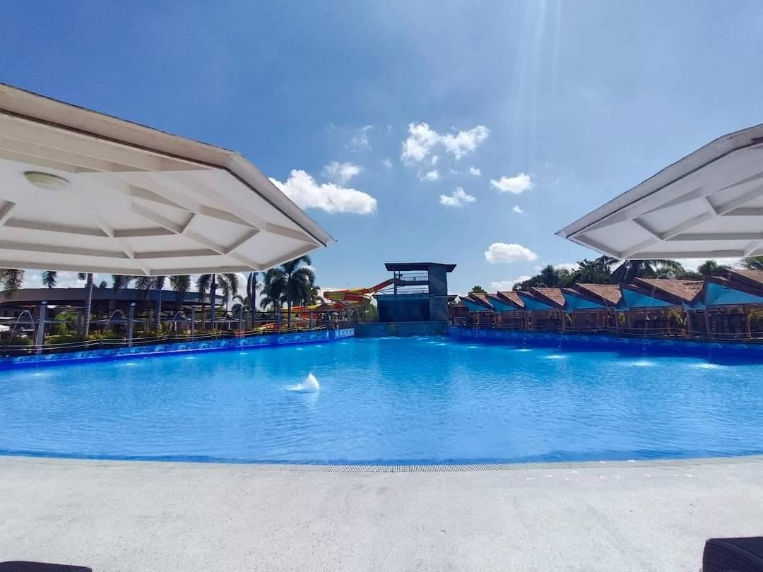 Wide wave pool under a bright blue sky