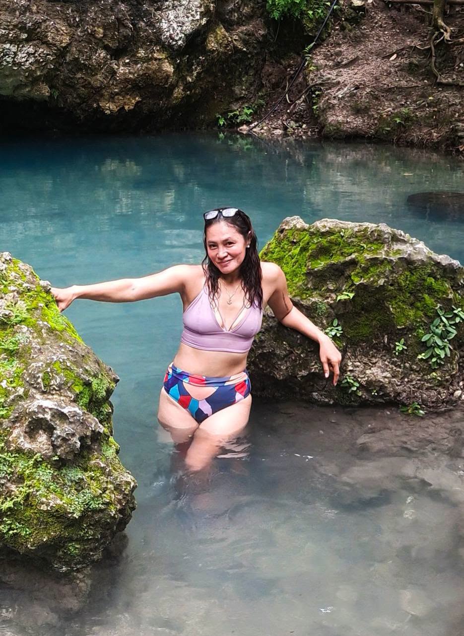 Irene Tan in a natural pool surrounded by rocks