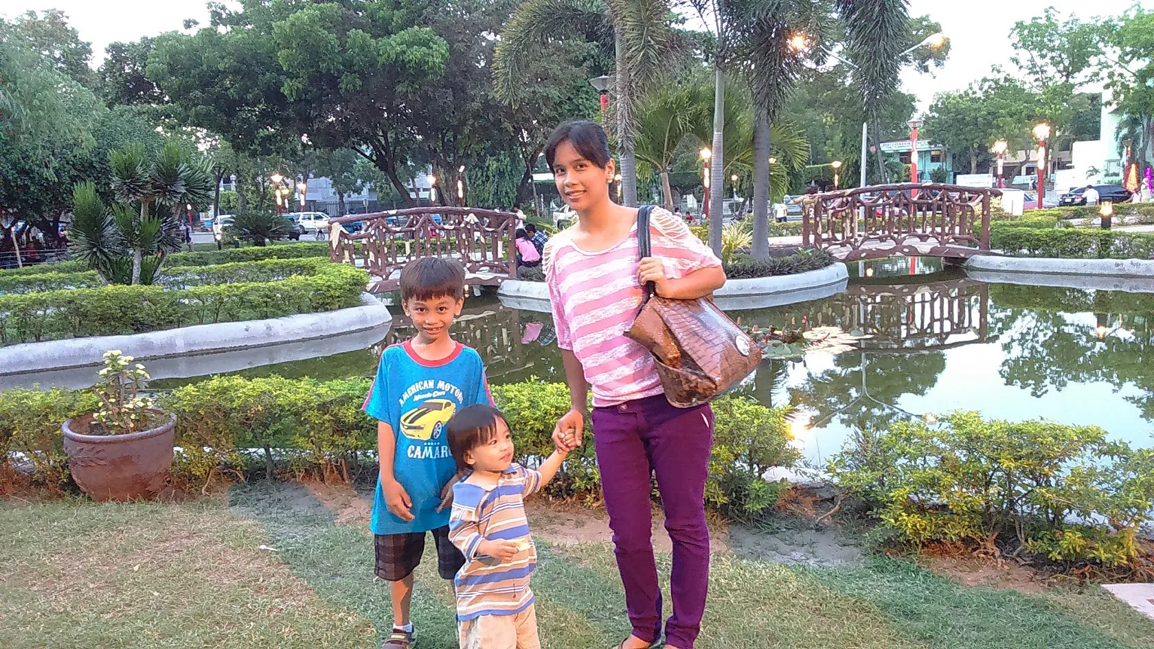 Family photo by the plaza lagoon and bridge