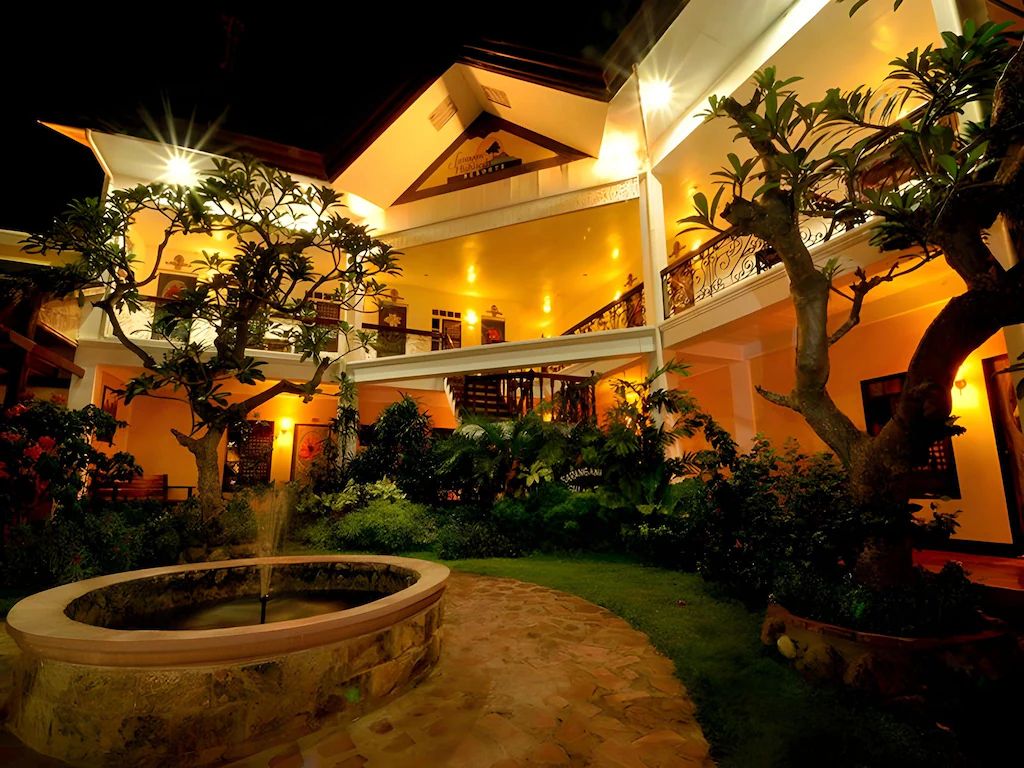 Sarangani Highlands Garden courtyard and hotel building glowing at night