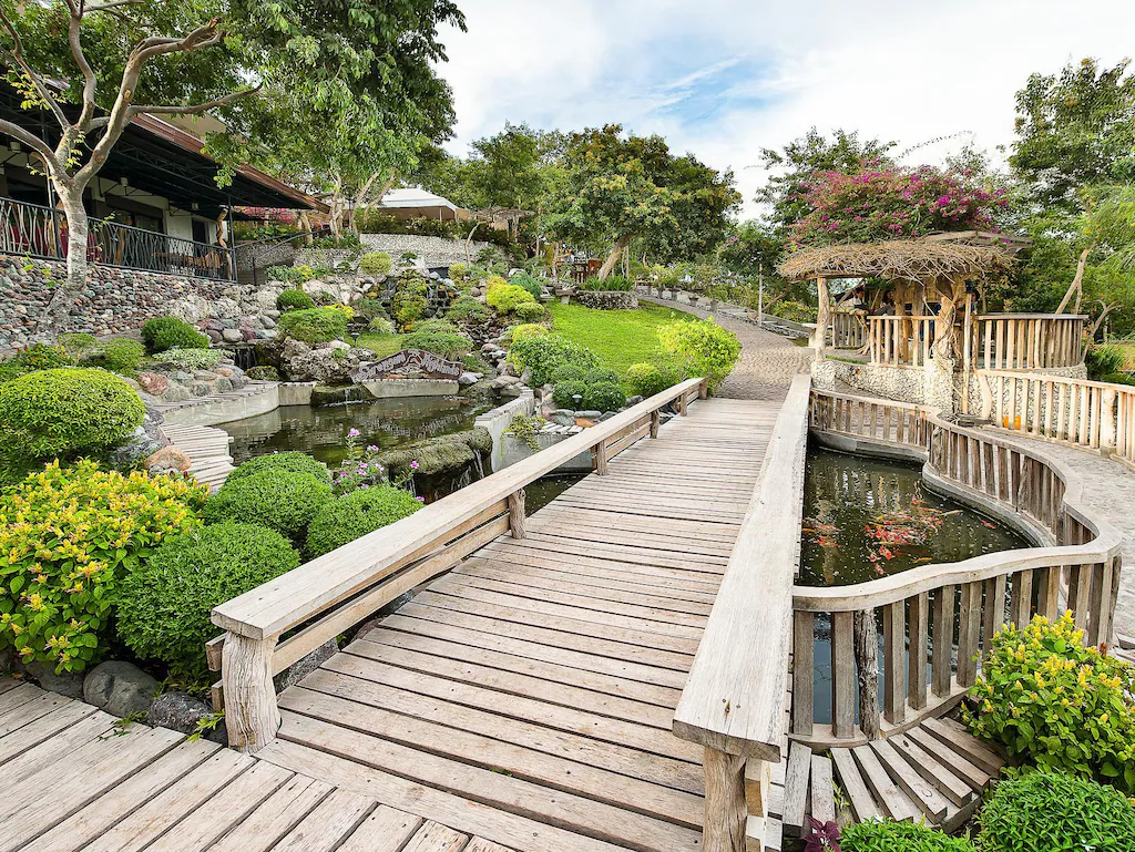 Wooden bridge and landscaped garden at Sarangani Highlands Garden