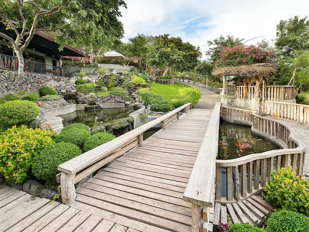 Wooden bridge and landscaped garden at Sarangani Highlands Garden