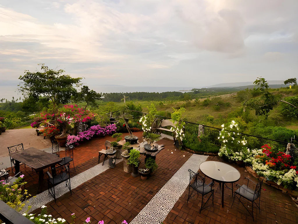 Flower-filled patio with highland and bay views