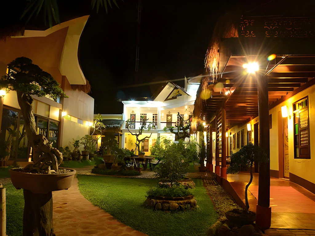 Warmly lit night garden and hotel rooms at Sarangani Highlands Garden