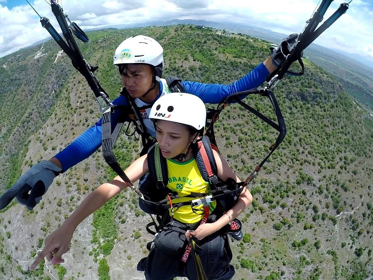 Tandem paragliding passenger enjoying the view from above