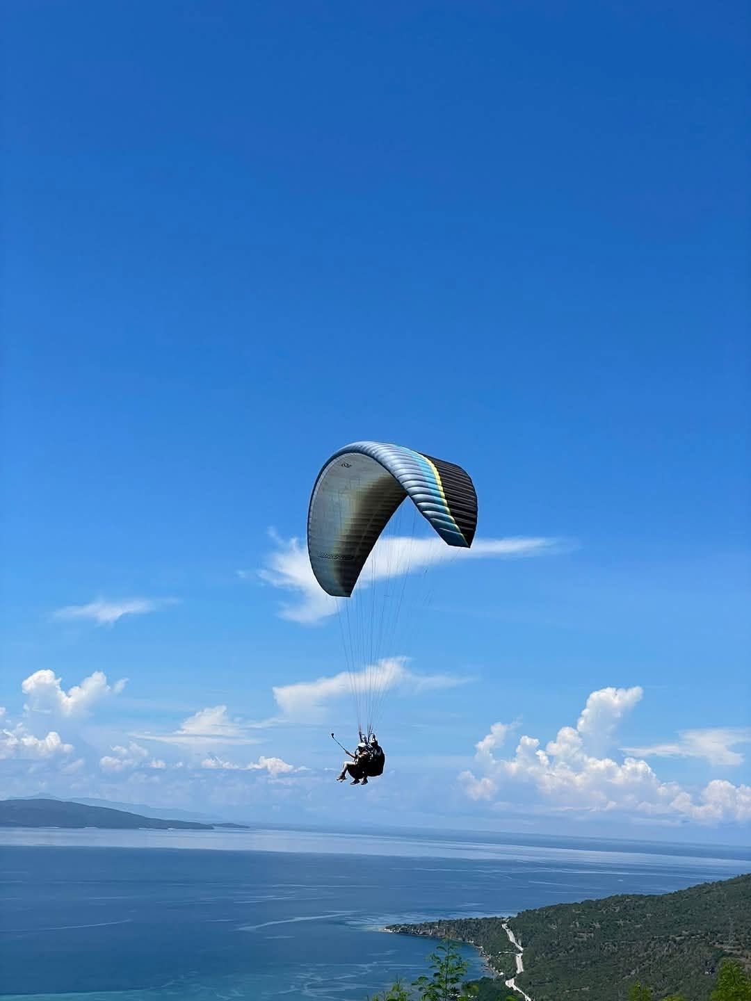 Paraglider flying above Sarangani Bay