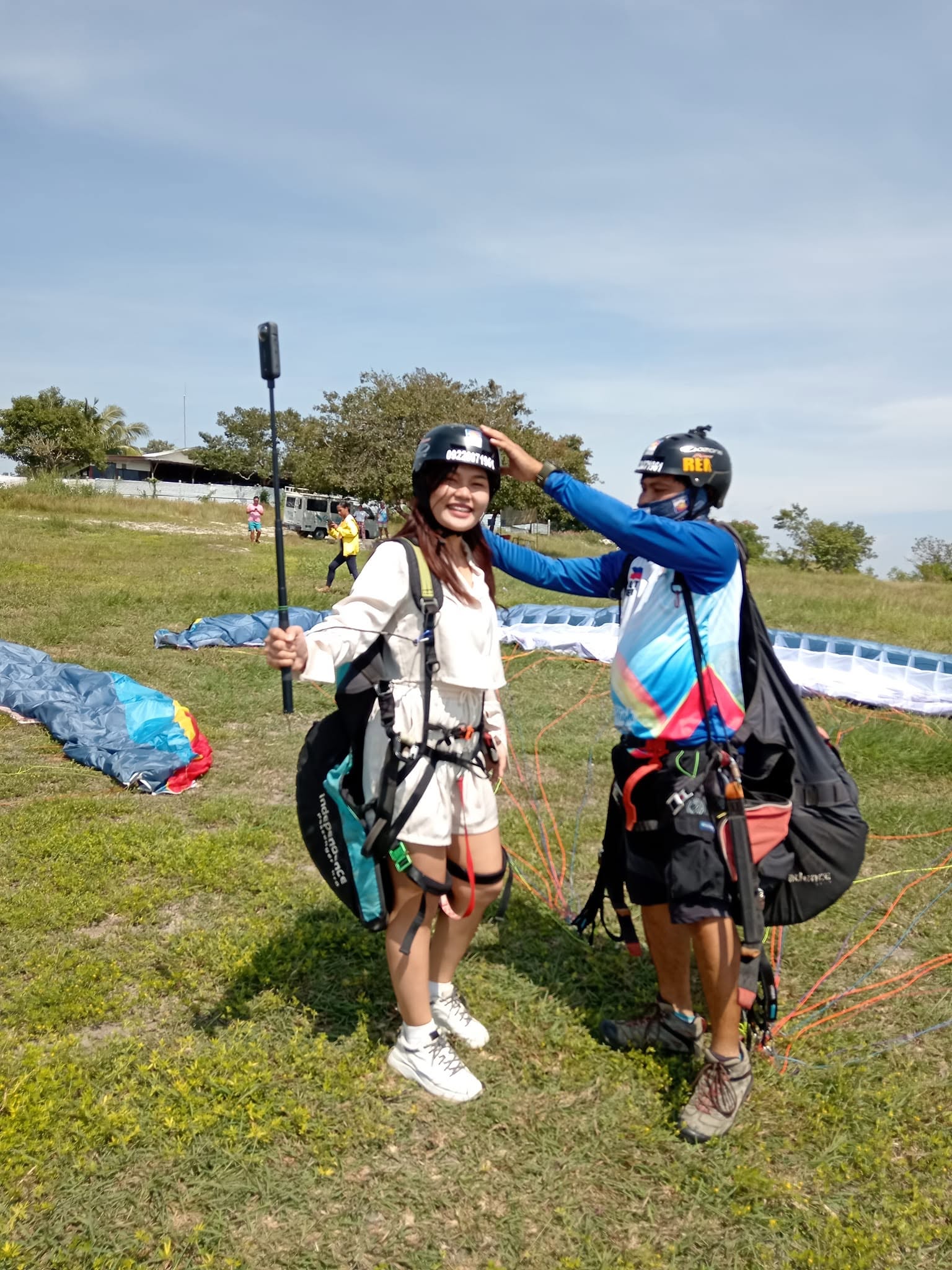 Soar High pilot assisting a guest before a tandem flight