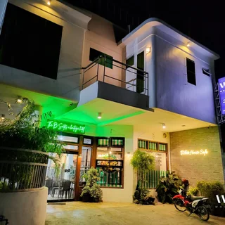 Illuminated building exterior and café entrance at night