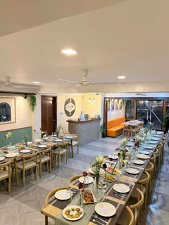 Dining room with long tables, flowers, and place settings